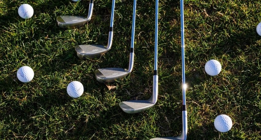 Black and white golf club on green grass field