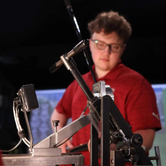 A man fitting the golf club with the a help of technology