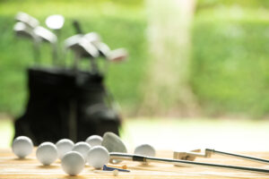 golf clubs and golf balls laid on a table