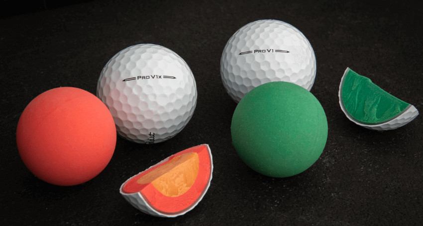 A variety of balls are displayed: two white dimpled Titleist golf balls on the left, a red and a green smooth ball in the center, and sections of both balls revealing their colorful interiors on the right.