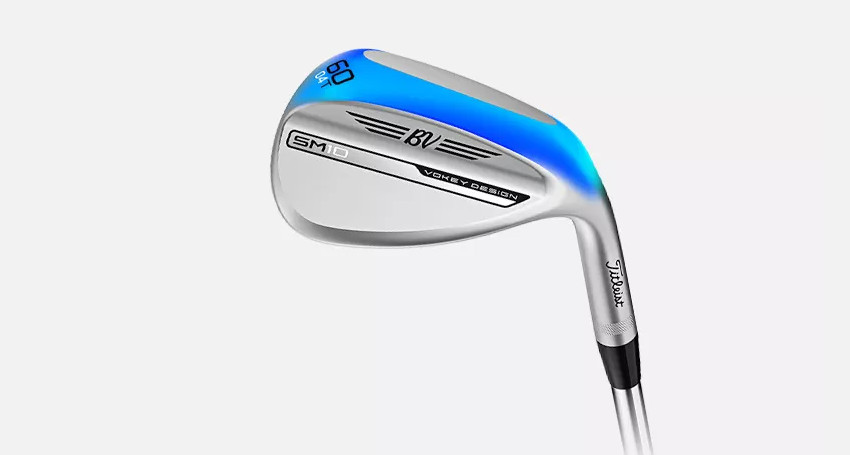 A chrome golf wedge with blue accents, marked "60" and "BV" near the blade, featuring "SM10 Vokey Design" text on the side against a white background.