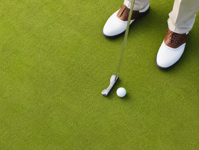Golfer addressing a putt on the green