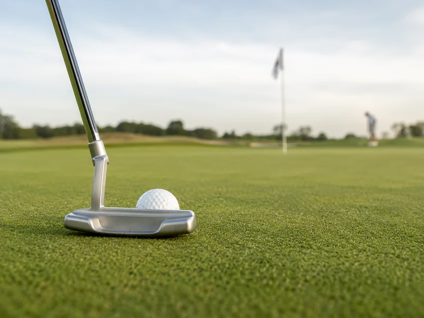 Putting practice with several golf balls on a green